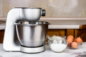 Electric mixer and ingredients for preparing biscuit cake.
