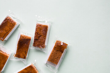 Cakes individually wrapped in plastic packaging, unsustainable product packaging, mini cakes in...