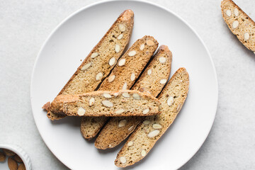 Overhead view of almond biscotti on a white plate, top view of almond cantucci cookies on a white plate, flatlay of biscotti cookies or twice baked cookies