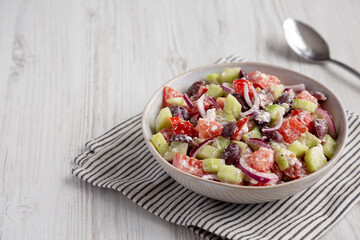 Homemade Chopped Mediterranean Salad in a Bowl, side view. Copy space.