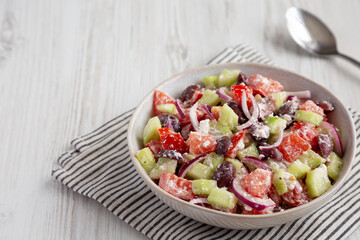 Homemade Chopped Mediterranean Salad in a Bowl, side view. Copy space.