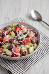 Homemade Chopped Mediterranean Salad in a Bowl, side view.
