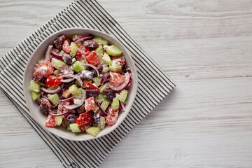 Homemade Chopped Mediterranean Salad in a Bowl, top view. Flat lay, overhead, from above. Copy space.