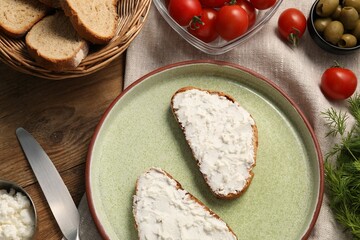 Delicious ricotta bruschettas and products on wooden table, flat lay