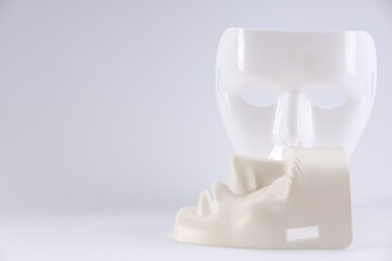 Plastic face masks on white background, space for text. Theatrical performance