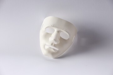 Plastic face mask on white background. Theatrical performance