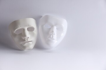 Plastic face masks on white background, space for text. Theatrical performance