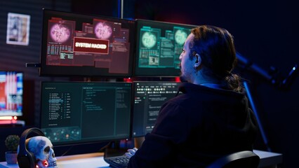 Happy hacker in apartment having burst of joy after managing to steal valuable data, using phishing...