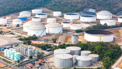 Aerial view oil storage tank, White oil tank storage chemical petroleum petrochemical refinery product at oil terminal, Business commercial trade fuel energy transport by tanker ship vessel.