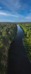 Obraz premium View from a height of a flying drone on a summer landscape. Lake and river, field and forest.