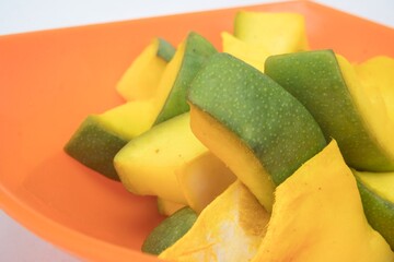 Very Close-Up View Of Slices of Mango for Mango Pickle In Saffron Color Bowl