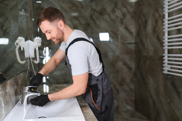 Plumber repairing the faucet of a sink