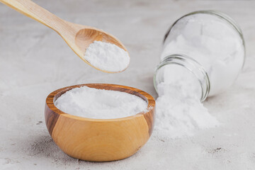 Baking soda in wooden container on rustic surface