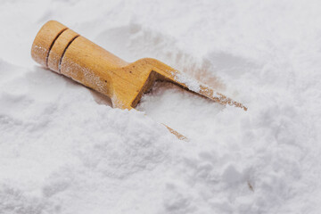 Baking soda on wooden spoon, close-up