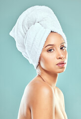 Portrait, woman and towel for hair in blue background, routine for healthy skincare and beauty. Face, female model and head cloth, natural glow for cosmetics or dermatology by wellness in studio