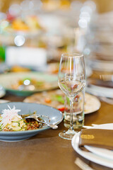 An empty wine glass and a glass on the served dining table. tableware for a banquet. catering services for the holiday.