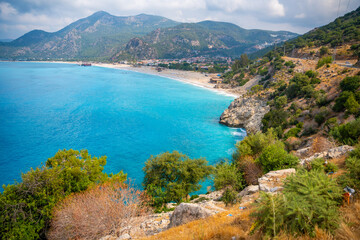 Aerial view of Oludeniz beach with people and boats in the morning, Coastline next to Fethiye, Turkey