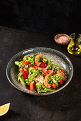 Fresh Shrimp and Strawberry Salad Bowl with Lettuce and Avocado in Rustic Setting