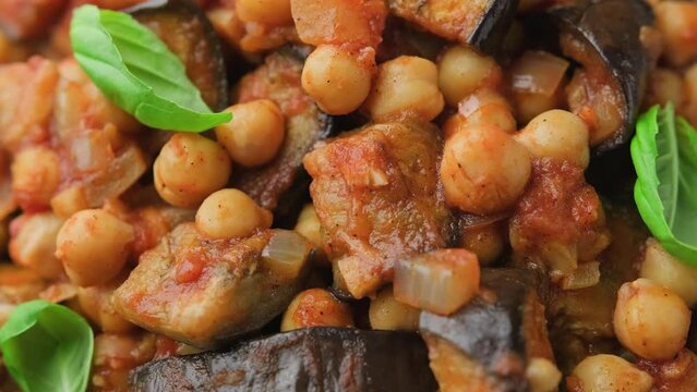 Eggplant and Chickpea Stew in tomato sauce, garlic and spices. Rotating video