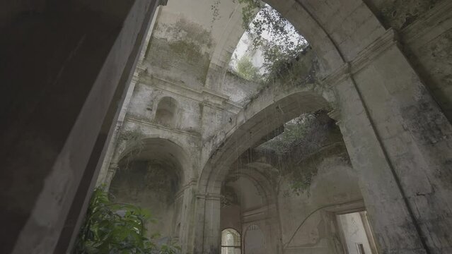 Abandoned church and abbey with arches and vegetation growing on the stone (S-Log 3)