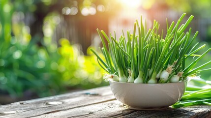 green fresh onion in a white bowl on a wooden table. Selective focus