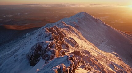 A serene landscape of a snowy mountain at sunset, with warm colors and no human presence