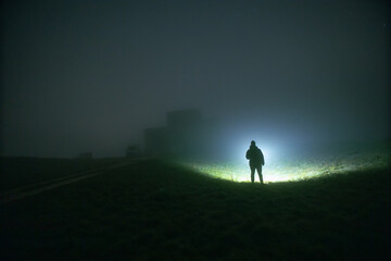 Fototapeta premium silhouette of a person in a fog field