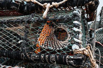 Weathered fishing nets and lobster traps on dock, intricate details and textures