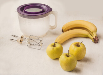 Milkshake (smoothie) and ingredients on the background of a bowl for a mixer