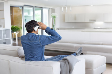Fototapeta premium relax casual Asian adult Man Wearing Virtual Reality Headset Play Video Game in living room at Home