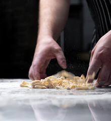 Cooking spaghetti, italian pasta, pasta on a black background. Food banner, large resolution.
