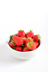 Strawberries in a white bowl. High-Key image.