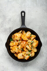 Fried cauliflower, with spices and herbs, in a cast-iron pan, homemade, no people,
