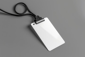 White empty ID card with lanyard on gray background. White lanyard with a blank id card on a gray background. blank name tag with lanyard on a grey background,a mockup template for design presentation