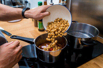 Chef at the kitchen preparing massaman curry with sweet potato and many spices