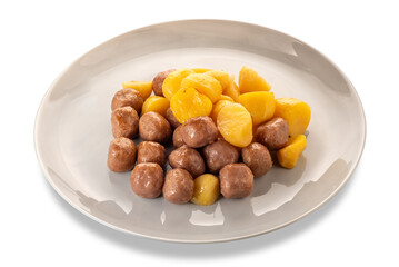 Small baked meatballs with roasted potatoes in plate isolated