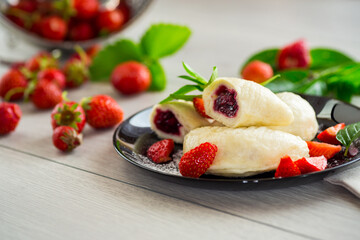 cooked sweet homemade steamed dumplings with strawberries