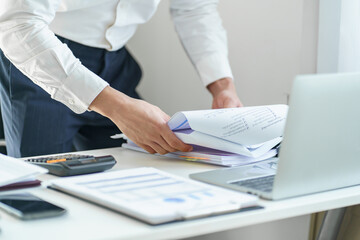 Young business man busy working at office. businessman doing financial paperwork business management concept