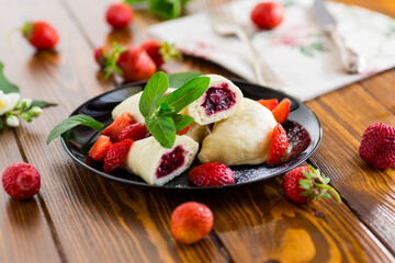 cooked sweet homemade steamed dumplings with strawberries