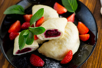cooked sweet homemade steamed dumplings with strawberries