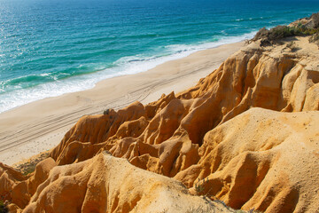beautiful beach in the Atlantic Ocean bordered by hard sand cliffs forming a canyon Medides beach in Portugal