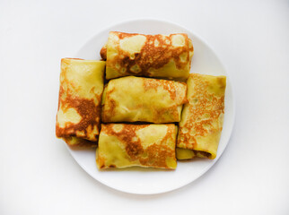 Pancakes with meat on a plate. Delicious envelopes with meat.