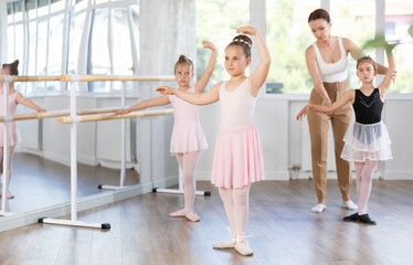 Little girls are learning various dance and ballet movements in the studio © JackF