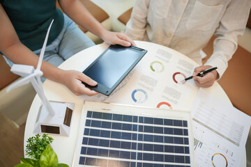 Solar panels green energy Business people working in green eco friendly office business...