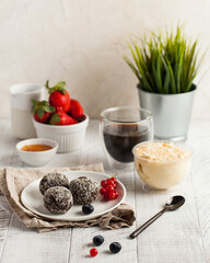 Chocolate ball candies with milk dessert and coffee on table