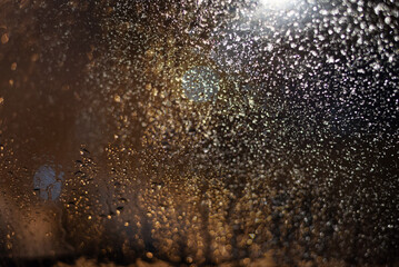 Blurred background with raindrops and lights.