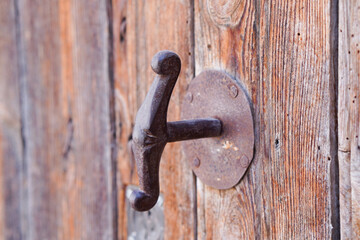 rusty antique iron door handle on wooden door