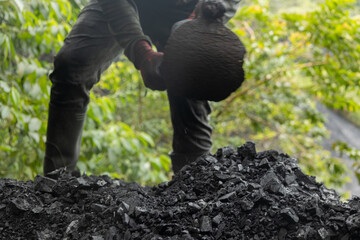 man working with shovel on the rocks outside the mine 