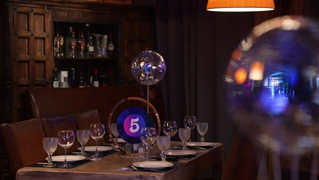 Create an elegant dining experience with a disco theme against a backdrop of a wine bar setting
