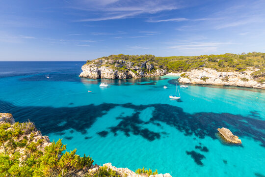 Macarella beach on the coast of Menorca, beautiful seaside landscape, white cliffs, turquoise sea, picturesque place for a holiday in Spain